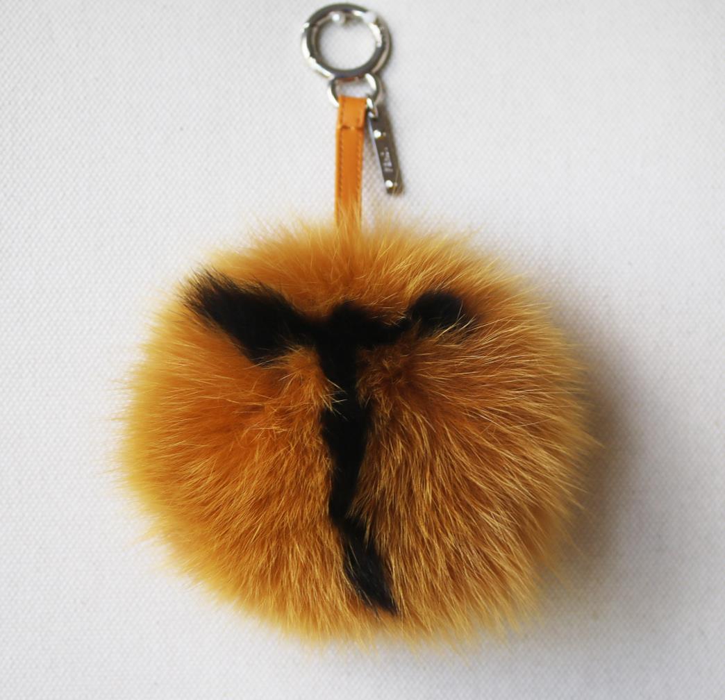 Currently craving: Fendi letter pompom fox-fur bag charms